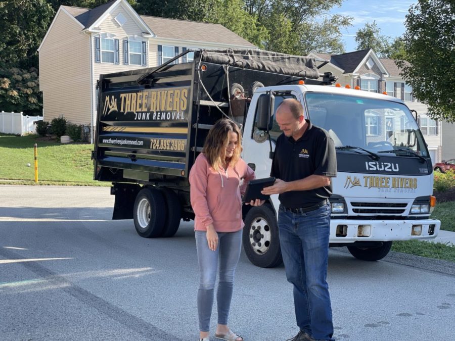 Three Rivers Junk Removal employee assisting customer with pricing