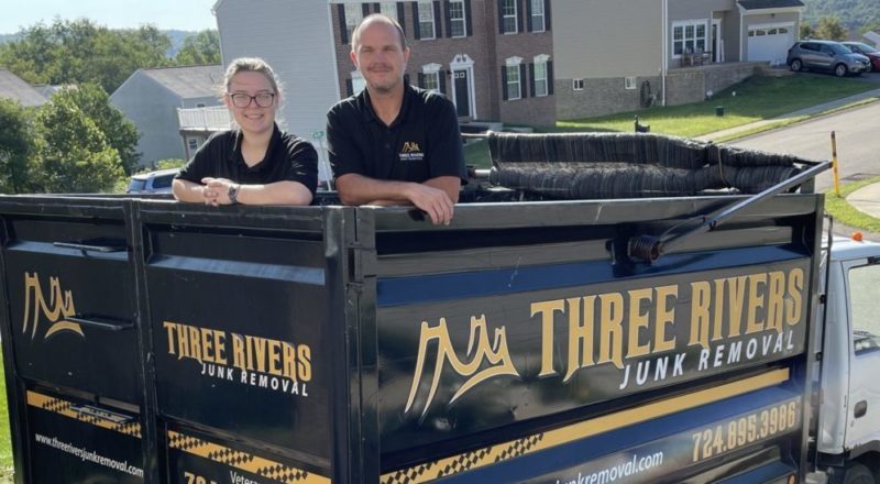 three rivers junk removal pros standing in bed of truck